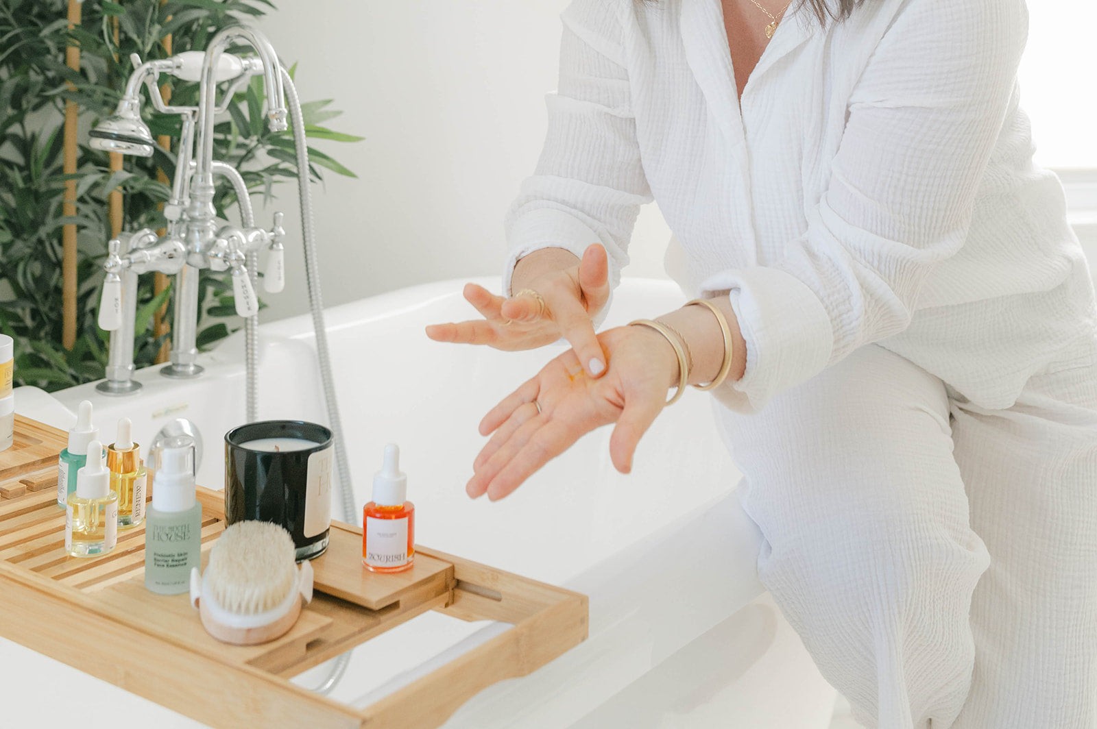 Glass skincare bottles and facial tools arranged for a daily ritual routine