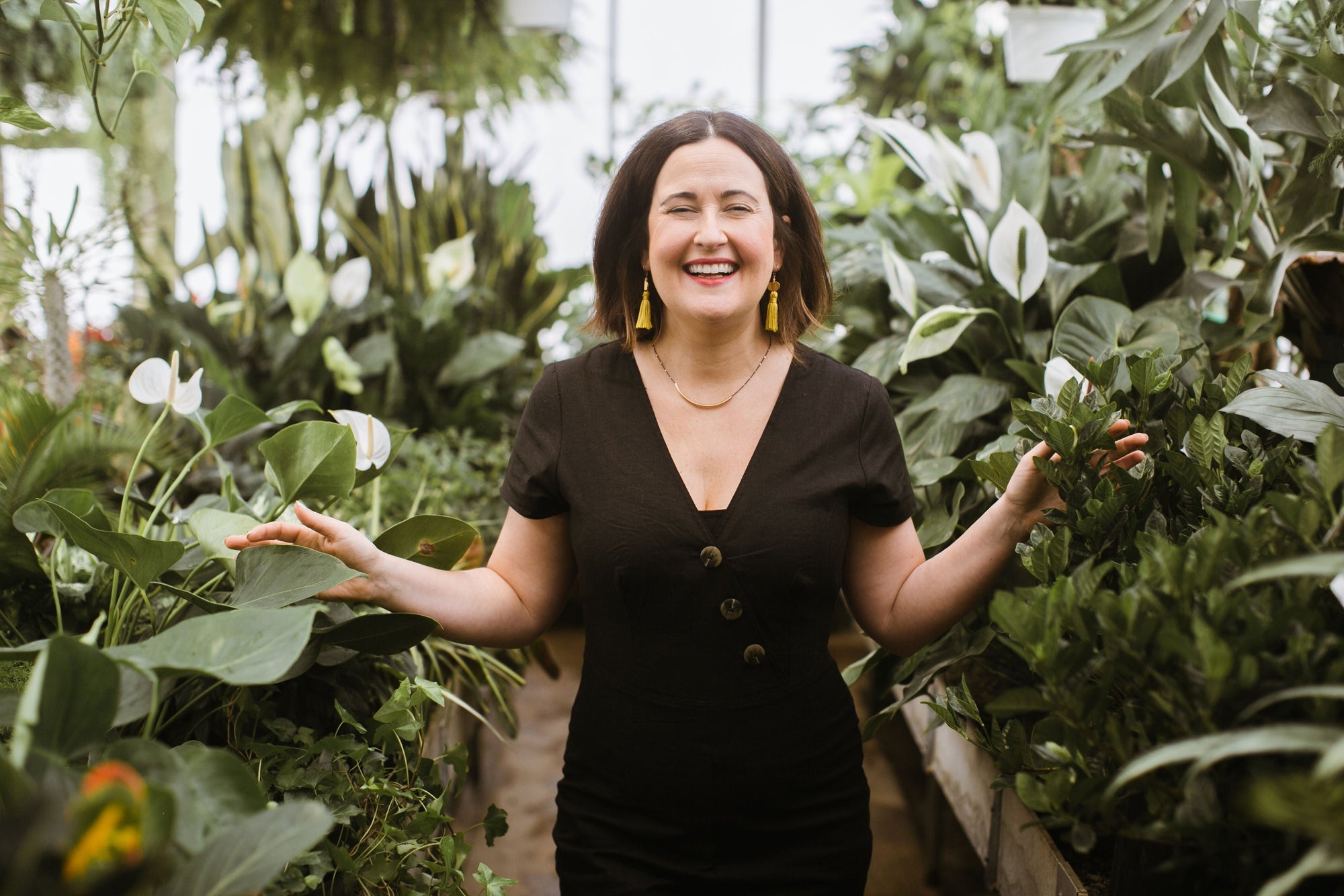 Picture of Jennie Fresa smiling and walking through greenhouse